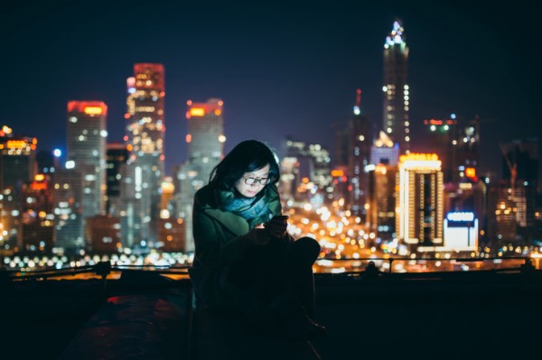 Young Asian Girl Using Smartphone in urban city